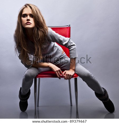 Gorgeous young woman sitting on a chair