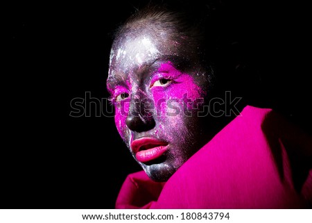 art photo of beautiful model with creative unusual black mask colorful makeup. black face