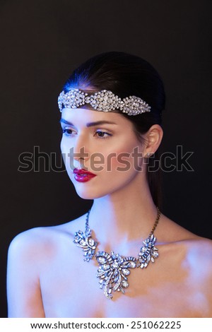 Beautiful woman with evening make-up, necklase and big jewelry on her head. Beauty face.