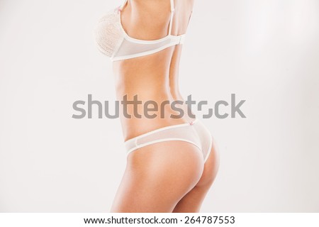 perfect women body. Cropped image of beautiful young woman in white underwear with perfect buttocks