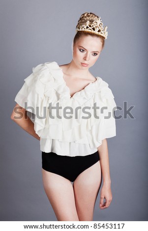 fashion portrait of a girl in a white blouse and black body with a pearl crown
