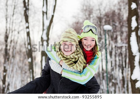 Winter couple  in snow smiling happy. Beautiful young couple