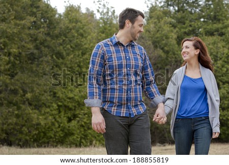 young couple wearing casual outfits in the park