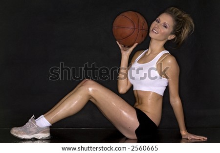 beautiful blond playing basketball wearing white shirt and black shorts