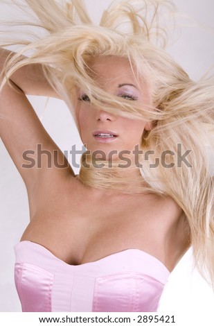 healthy beautiful blond long hair in motion created by wind, fashion look