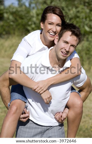 couple in love doing piggy back during fall days