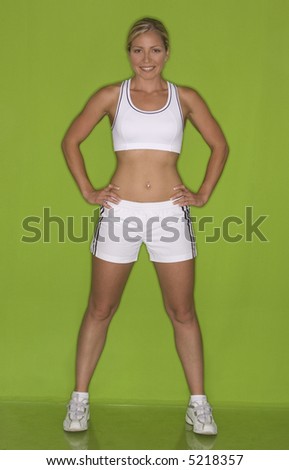 healthy fitness model posing on green isolated background