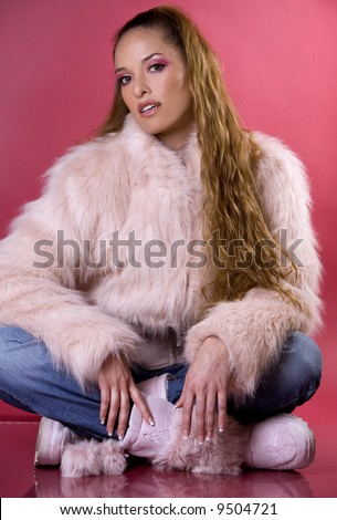 pretty model wearing pink fur coat and blue jeans
