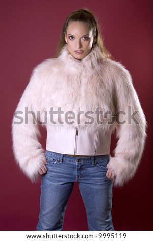 pretty model wearing pink fur coat and blue jeans