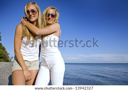 sisters wearing yellow top and jeans in the summer