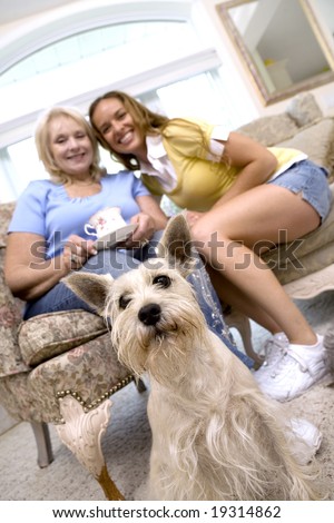 mother and daughter enjoying coffee with their dog