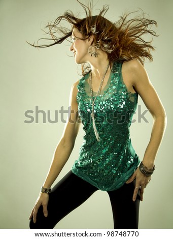 pretty brunette wearing green outfit on light background