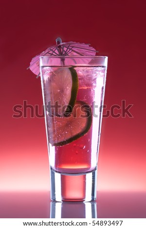 Cool, fresh, red cocktail with lime on a red background