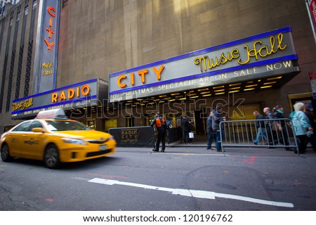NEW YORK CITY - DEC. 2: Yellow taxi drives by New York City landmark, Radio City Music Hall in Rockefeller Center on Dec. 2, 2011. Radio City is home of the Rockettes and annual Christmas Spectacular.