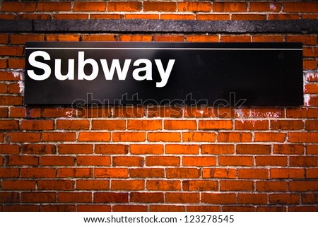 New York City subway sign entrance on brick wall