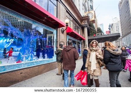 NEW YORK CITY - DEC 13: Spectators view holiday window display at Macy\'s Herald Square in NYC on Dec 13, 2013. Since the early 1870s Macys has been stunning visitors with holiday window displays
