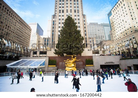 NEW YORK CITY - DEC 13: Visitors at Rockefeller Center in NYC on Dec 13, 2013. Declared a National Historic Landmark Rockefeller Ctr. is home to the iconic NYC Christmas Tree and ice skating rink.