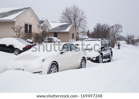 WEST HEMPSTEAD,  NY - JAN 3:  Snow covered cars on Long Island, NY on Jan 3 2014 after snow storm. This powerful nor\'easter named Hercules caused blizzard conditions on Long Island.