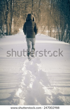 Female and footsteps in snow