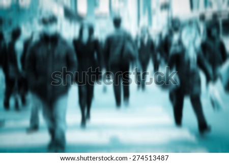 Blue of pedestrians on crowded city street. Toned image