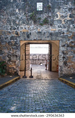 OLD SAN JUAN, PUERTO RICO - MARCH 29, 2015:  Stone wall and gate entrance leading to Puerta De San Juan in Old San Juan Puerto Rico.