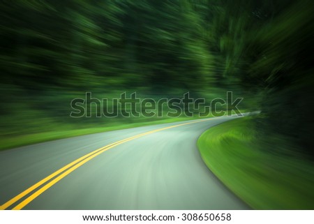 Curved road through country road with motion blur