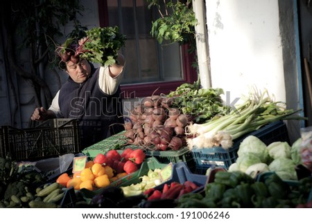 ERMOUPOLI, GREECE - MAY 26: Farmer sells produce at a local market on May 26, 2011 in Ermoupoli, Syros, Greece.