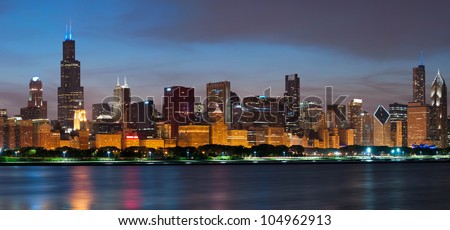 Chicago skyline. Image of Chicago skyline at night with reflection of the city lights in Lake Michigan.