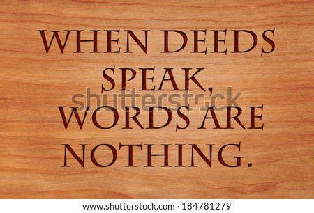 When deeds speak, words are nothing - motivational African Proverb on wooden red oak background