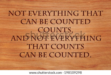 Not everything that can be counted counts, and not everything that counts can be counted - quote on wooden red oak background