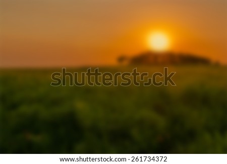 Abstract blurred background of a sunrise over a country landscape