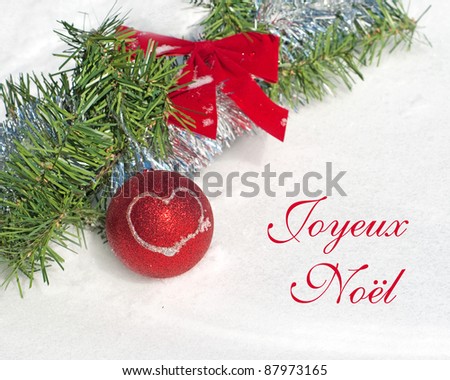 Red Christmas ball ornament with a heart and text Joyeux Noel, Merry Christmas in French