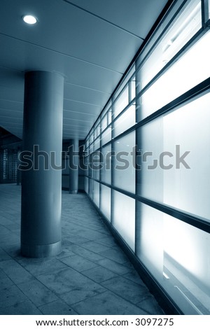 Glowing glass in modern building facade with white light from inside