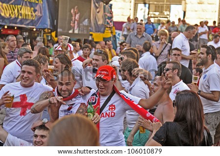 KIEV, UKRAINE - 24 JUNE 2012: Fans of England football command funs, drink beer and take images  in fan zone in Kiev  before match England - Italy of Euro-2012 24 June 2012 in Kiev.