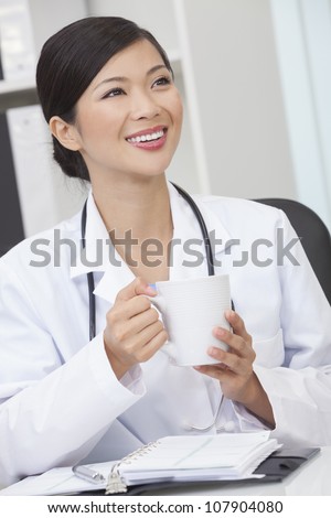 A Chinese Asian female medical doctor drinking tea or coffee in a hospital office