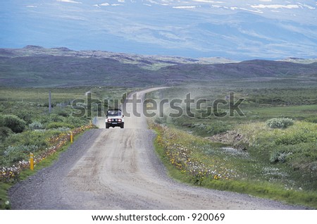 A four wheel drive vehicle drives through the Icelandic countryside