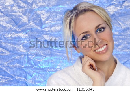 A stunningly beautiful young blond woman shot against an electric blue background