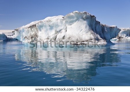 A glacial iceberg and its reflection floating on the Iceberg Lagoon, Jokulsarlon, Iceland