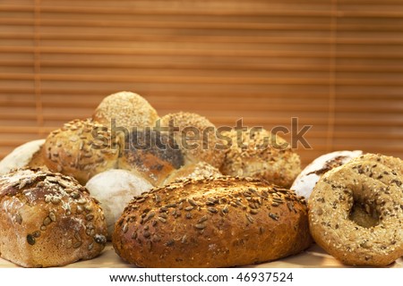 A selection of rustic, wholemeal and seeded handmade breads shot in golden sunlight