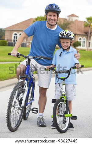A young family of man and boy, father and one boy child, cycling together.