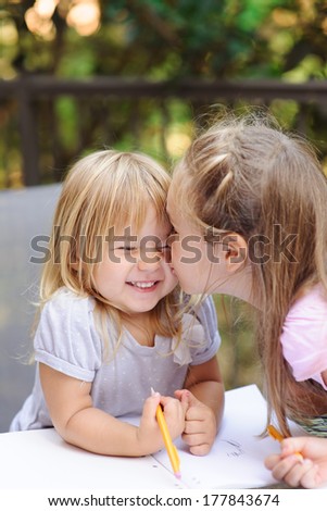 two little sister kissing