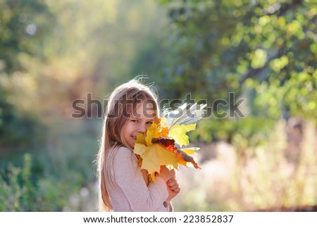 Happy cute girl in autumn fall outdoor