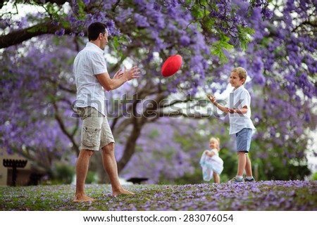 Father teach son playing rugby