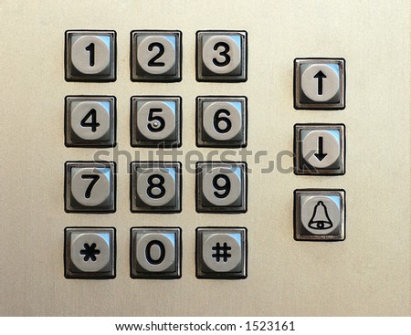 Numeric keypad made of metal with black digits that includes arrows and call buttons
