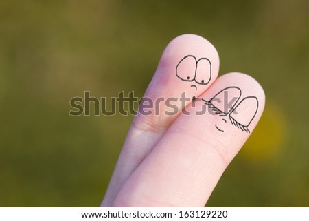 Two fingers of a hand characterized symbolizing a couple of lovers