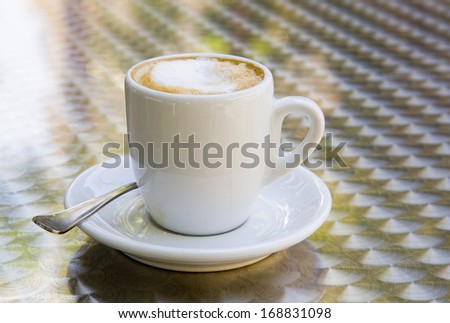White cup with coffee and milk