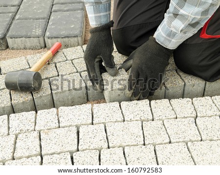 Paver laying pathway out of concrete pavement blocks