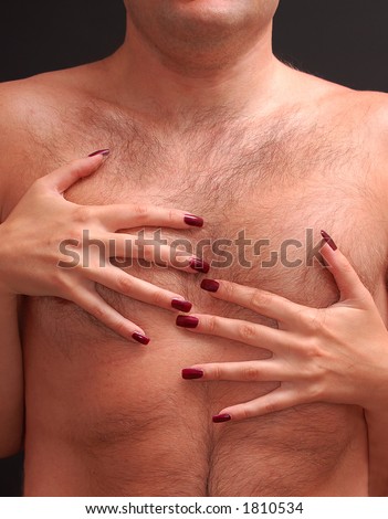 Woman with deep red fingernails embracing man\'s hairy torso