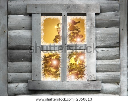 Closeup of christmas tree with lights seen through a wooden cabin window