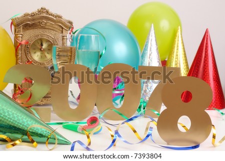 Old 2007 year with digit number seven covered by digit eight to show New year is coming with table clock streamers, balloons, party hats and two glasses of champagne in the background